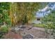 Landscaped backyard with bamboo plants and stone features at 7739 Westmoreland Dr, Sarasota, FL 34243