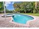 Inviting kidney-shaped pool with a spa at 7739 Westmoreland Dr, Sarasota, FL 34243