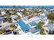 Elevated view showcasing a house with a blue roof, deck, and spiral staircase at 792 Jacaranda Rd, Anna Maria, FL 34216