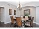 Bright dining room with elegant chandelier and table at 8110 Grand Estuary Trl # 104, Bradenton, FL 34212