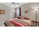 Spacious bedroom with a king-size bed and red and beige bedding at 8956 Huntington Pointe Dr, Sarasota, FL 34238