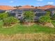 Expansive pool and spa with screened enclosure and tropical landscaping at 10141 Colubrina Dr, Venice, FL 34293