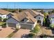 Home with tile roof, two-car garage, and view of preserve at 11265 Mc Dermott Ct, Englewood, FL 34223