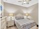 Cozy guest bedroom with comfortable bed, matching nightstands, and ceiling fan at 11265 Mc Dermott Ct, Englewood, FL 34223