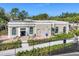 Community clubhouse with seating area near the tennis courts at 11265 Mc Dermott Ct, Englewood, FL 34223