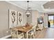 Dining area with a stylish table, chandelier, and views of the outdoors at 11265 Mc Dermott Ct, Englewood, FL 34223
