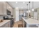 Modern kitchen featuring stainless steel appliances, large island, and ample counter space at 11265 Mc Dermott Ct, Englewood, FL 34223