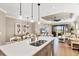 Kitchen island with a double sink, stainless steel appliances, and pendant lighting at 11265 Mc Dermott Ct, Englewood, FL 34223