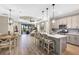 Open-concept kitchen and dining area with views of the living room and access to the outdoors at 11265 Mc Dermott Ct, Englewood, FL 34223