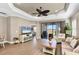 Spacious living room with tray ceiling, large sliding door, and plenty of natural light at 11265 Mc Dermott Ct, Englewood, FL 34223