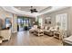 Inviting living room with sliding glass doors, ceiling fan, and comfortable seating area at 11265 Mc Dermott Ct, Englewood, FL 34223