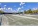 Two empty tennis courts on a beautiful day at 11265 Mc Dermott Ct, Englewood, FL 34223