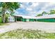 Green barn with attached shed and small house at 1130 Anclote Rd, Tarpon Springs, FL 34689