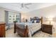 Bedroom with wood bed frame, dresser, and ceiling fan at 1650 1St W Ave # 302B, Bradenton, FL 34205