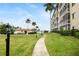 Walkway to pool and building, lush green grass at 1650 1St W Ave # 302B, Bradenton, FL 34205