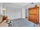 Bedroom with ample closet space, wooden dresser, and plush carpeting at 1720 Starling Dr # 103, Sarasota, FL 34231