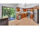 Updated kitchen with stainless steel appliances, wood cabinets, and sliding glass doors to the patio at 1720 Starling Dr # 103, Sarasota, FL 34231