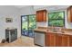 Kitchen features wood cabinetry, granite countertops, stainless steel appliances, and a wine fridge at 1720 Starling Dr # 103, Sarasota, FL 34231