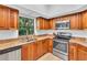 Kitchen boasts stainless steel appliances, wood cabinets, granite countertops, and ample counter space at 1720 Starling Dr # 103, Sarasota, FL 34231