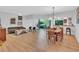 Open-concept living and dining area with wood floors and modern furniture at 1720 Starling Dr # 103, Sarasota, FL 34231