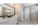 Modern bathroom with double sink vanity, sleek fixtures, and glass-enclosed shower at 17744 Savory Mist Cir, Bradenton, FL 34211