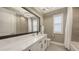 Bathroom with a large framed mirror and shower with sleek countertops at 17744 Savory Mist Cir, Bradenton, FL 34211