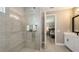 Modern bathroom with sleek fixtures, and glass-enclosed shower, and access to the bedroom at 17744 Savory Mist Cir, Bradenton, FL 34211