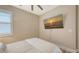 Bright bedroom featuring a wall-mounted TV for entertainment and shuttered windows at 17744 Savory Mist Cir, Bradenton, FL 34211