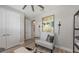 Cozy bedroom featuring a stylish accent chair and unique wall decor at 17744 Savory Mist Cir, Bradenton, FL 34211