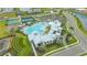 Aerial view of the large community pool, tennis courts, playground, and landscaping at 17744 Savory Mist Cir, Bradenton, FL 34211