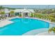 Spacious community pool with lounge chairs and shaded areas for relaxation and socializing at 17744 Savory Mist Cir, Bradenton, FL 34211