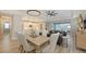 Elegant dining area open to the living room with stylish seating and great lighting and direct access to the patio at 17744 Savory Mist Cir, Bradenton, FL 34211