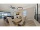Comfortable dining space open to the living room showcasing modern decor and great natural light through shuttered windows at 17744 Savory Mist Cir, Bradenton, FL 34211