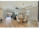 Open concept dining area with wood table and modern lighting at 17744 Savory Mist Cir, Bradenton, FL 34211