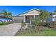 Charming single-story home boasts a beautifully landscaped front yard and a two-car garage at 17744 Savory Mist Cir, Bradenton, FL 34211