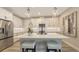 Well-equipped kitchen featuring a center island, modern appliances, and beautiful pendant lighting and bar seating at 17744 Savory Mist Cir, Bradenton, FL 34211
