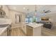 Open kitchen design with a center island, stainless steel appliances, and a view into the living room at 17744 Savory Mist Cir, Bradenton, FL 34211