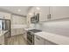Modern kitchen with sleek countertops, stainless steel appliances, and white cabinetry, great for cooking and gatherings at 17744 Savory Mist Cir, Bradenton, FL 34211