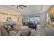 Open-concept living space seamlessly blends with the kitchen and offers views of the pool area and outdoor patio at 17744 Savory Mist Cir, Bradenton, FL 34211