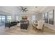 Spacious living and dining area with sleek furnishings, a stylish chandelier, and a serene atmosphere at 17744 Savory Mist Cir, Bradenton, FL 34211