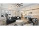Open concept living room with modern furnishings, beautiful lighting, and open flow to kitchen and dining area at 17744 Savory Mist Cir, Bradenton, FL 34211
