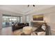 Comfortable living room with a large screen TV, modern decor, and a view of the outdoor pool area at 17744 Savory Mist Cir, Bradenton, FL 34211