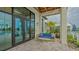 Relax on the covered patio with comfortable seating, offering a serene outdoor retreat with a pool view at 17744 Savory Mist Cir, Bradenton, FL 34211