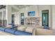 Enjoy the covered outdoor living space with a stone fireplace and TV, ideal for relaxation and entertainment at 17744 Savory Mist Cir, Bradenton, FL 34211