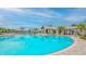 Enjoy resort-style living with this large community pool surrounded by lush landscaping and comfortable lounge seating at 17744 Savory Mist Cir, Bradenton, FL 34211