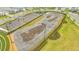 Aerial view of the community pump track, featuring asphalt runs and professional landscaping at 17744 Savory Mist Cir, Bradenton, FL 34211