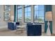 Cozy sitting area with elegant blue chairs, stylish decor, and scenic views at 17744 Savory Mist Cir, Bradenton, FL 34211
