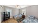 Bright bedroom with two twin beds, wood floors, and plantation shutters at 1775 Stapleton St, Sarasota, FL 34239