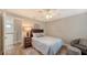 Bedroom with queen bed, wood floors, ceiling fan, and adjacent sitting area at 1775 Stapleton St, Sarasota, FL 34239