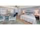 Bright studio apartment features a full size bed, dining area, and wicker chairs at 1775 Stapleton St, Sarasota, FL 34239